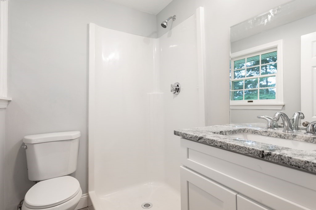 14 Fairbrook Road Framingham, MA 01701 - Photo 20 of 24 a bathroom with a granite countertop sink toilet and shower