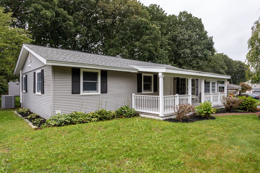 14 Fairbrook Road Framingham, MA 01701 - Photo 2 of 24 a backyard of a house with potted plants and large tree