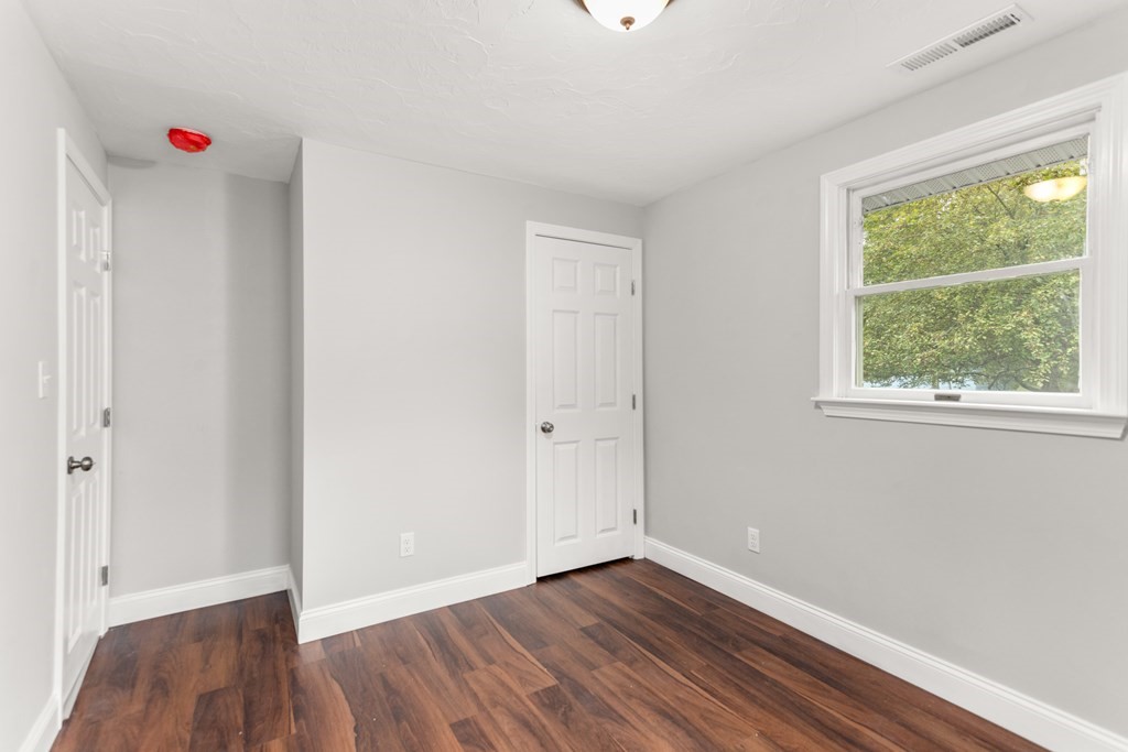 14 Fairbrook Road Framingham, MA 01701 - Photo 22 of 24 a view of an empty room with wooden floor and a window