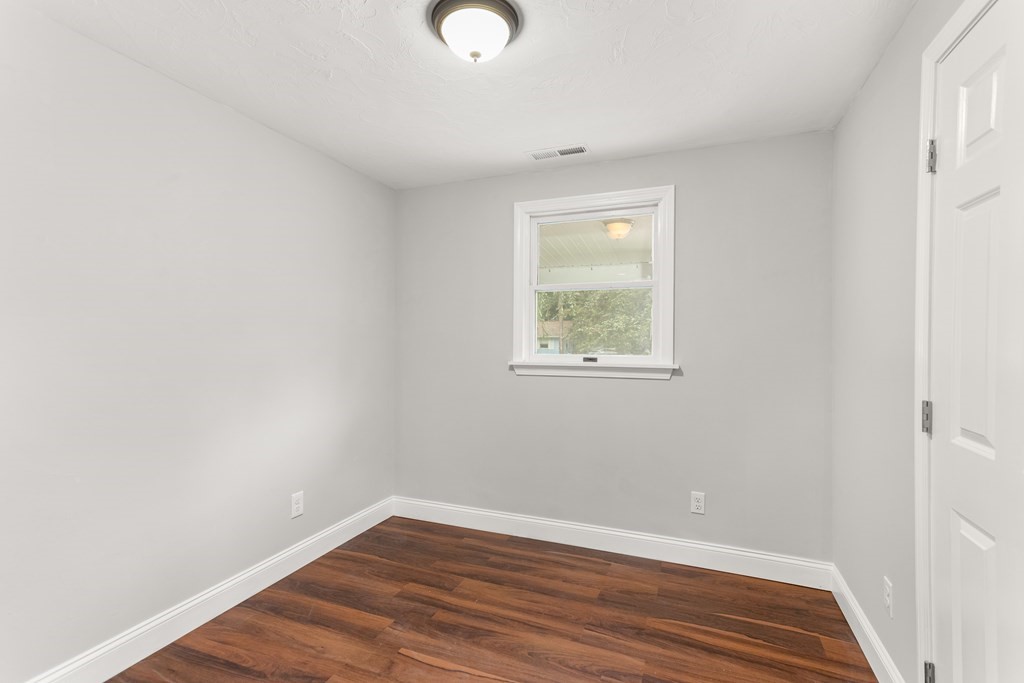 14 Fairbrook Road Framingham, MA 01701 - Photo 23 of 24 a view of an empty room with wooden floor and a window