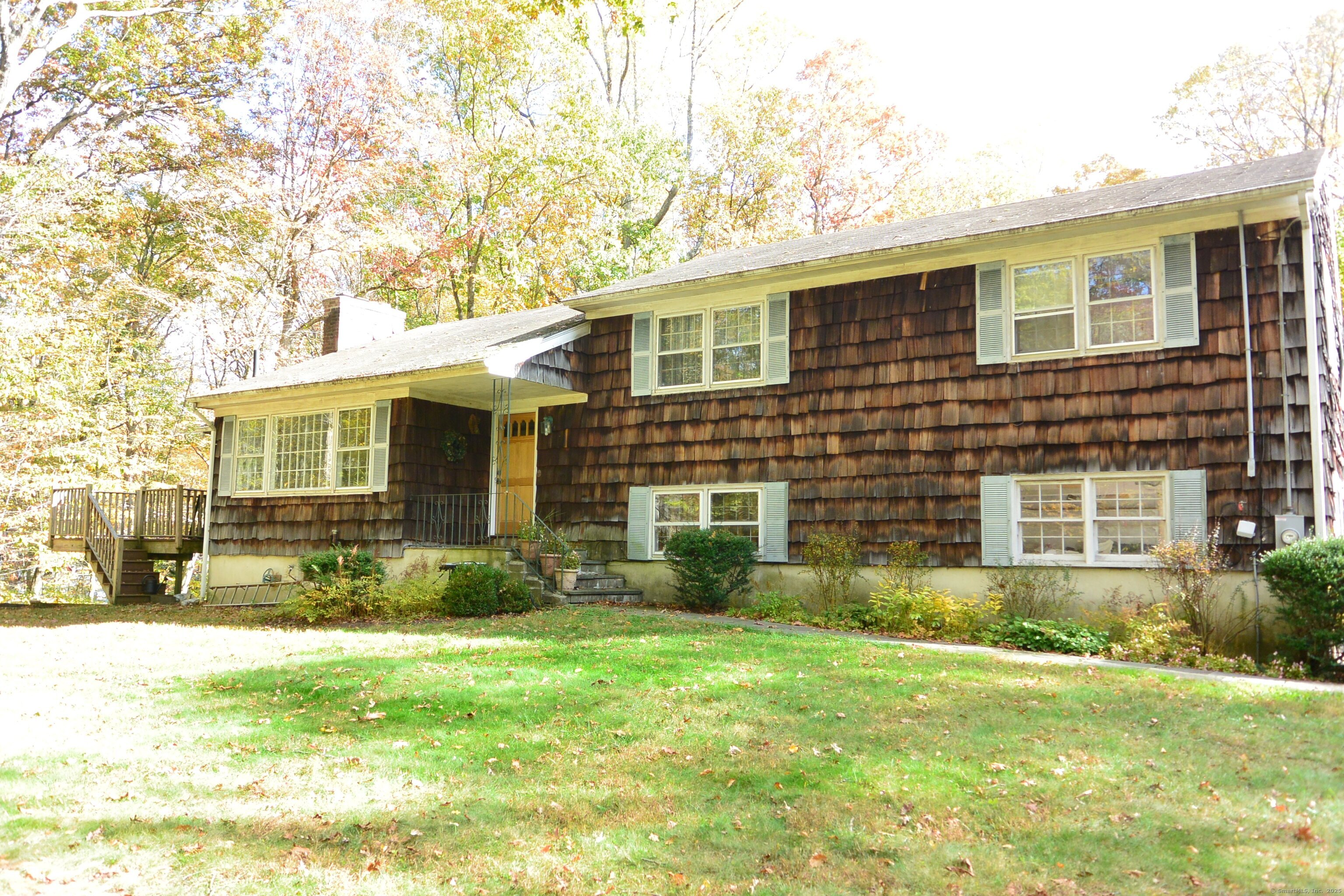 439 Cheese Spring Road New Canaan, CT 06840 - Photo 1 of 36 a front view of a house with a yard and garage