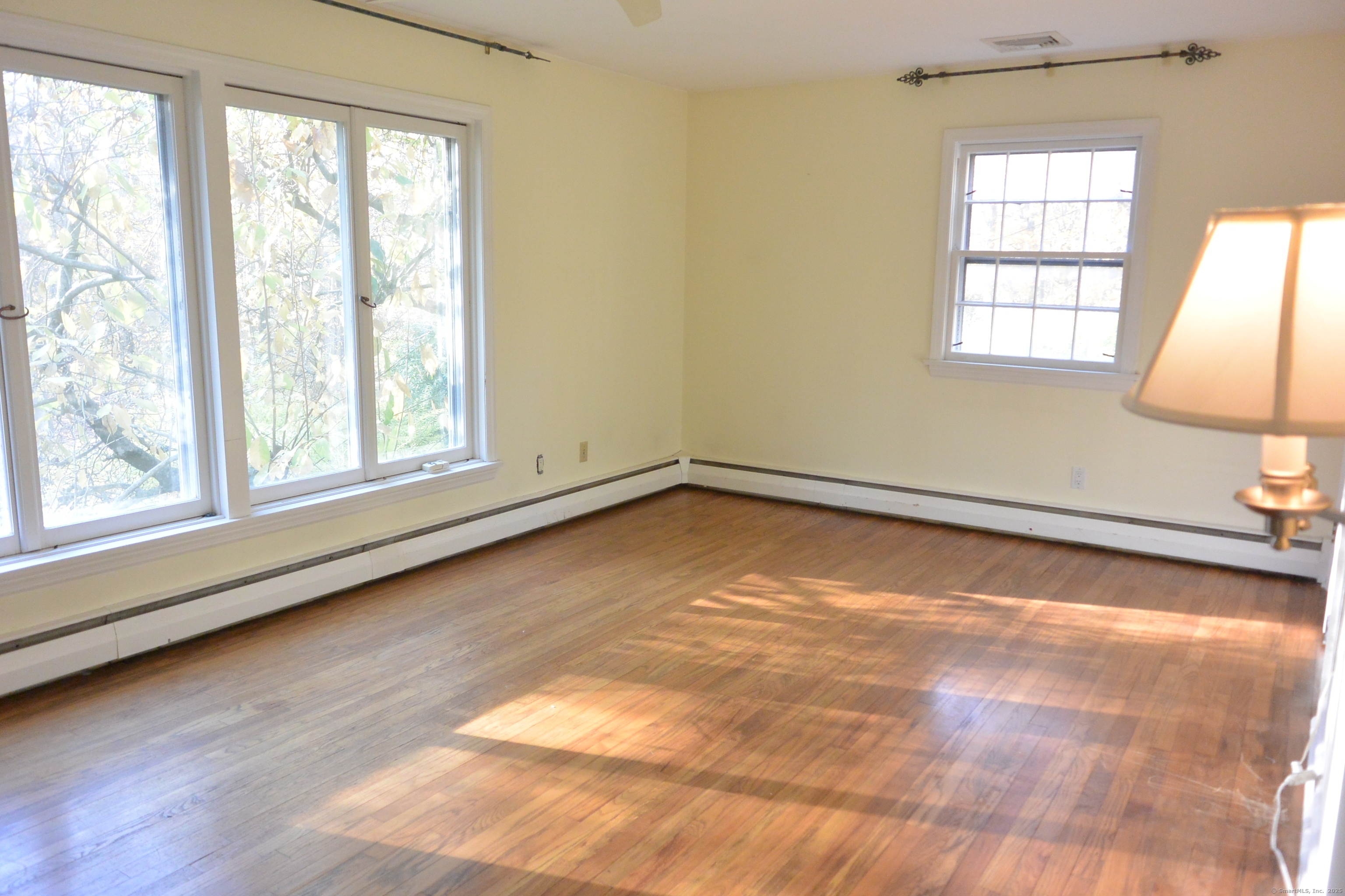 439 Cheese Spring Road New Canaan, CT 06840 - Photo 13 of 36 an empty room with wooden floor and windows