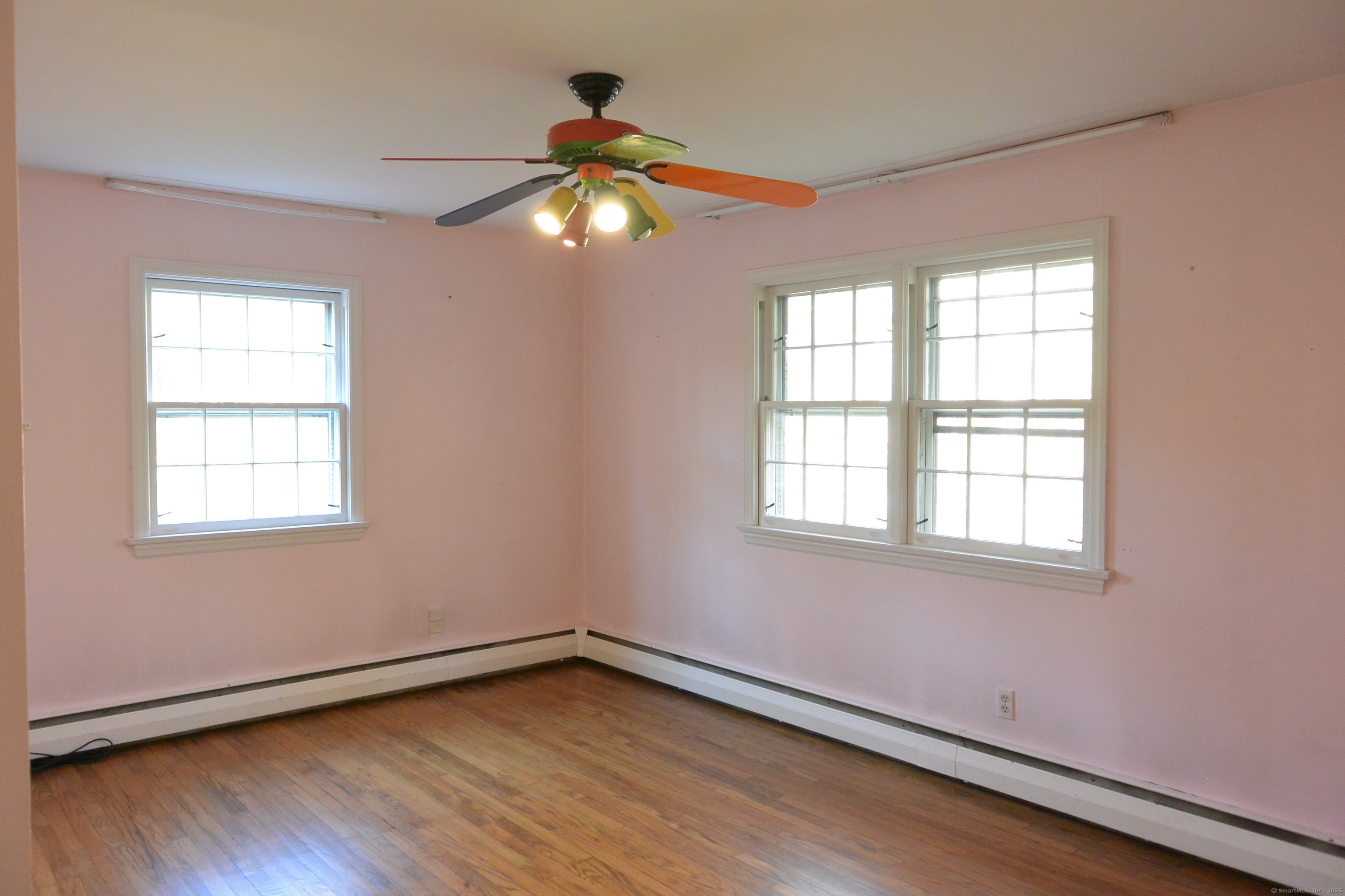 439 Cheese Spring Road New Canaan, CT 06840 - Photo 16 of 36 a view of an empty room with wooden floor and a window