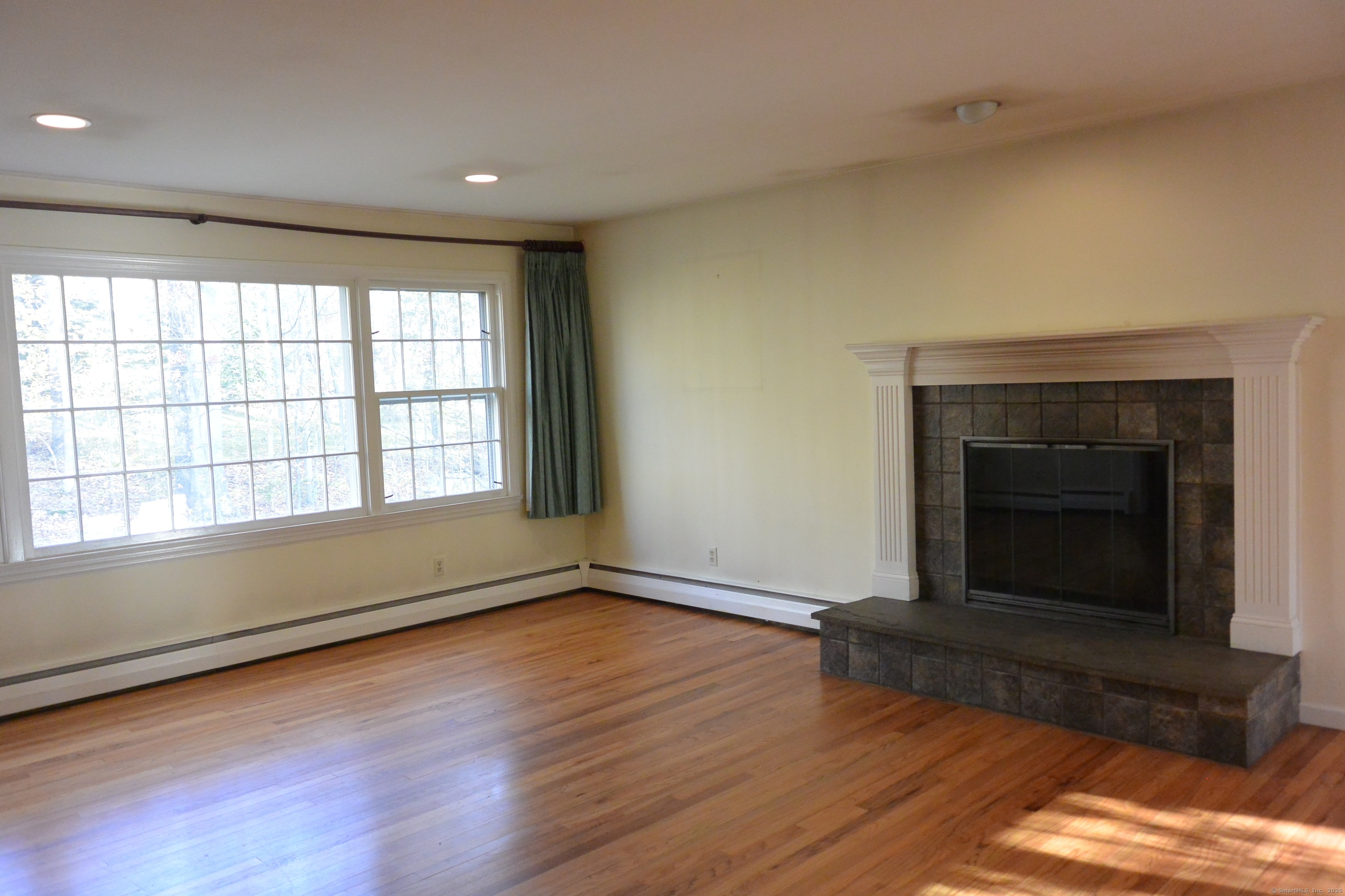 439 Cheese Spring Road New Canaan, CT 06840 - Photo 5 of 36 wooden floor fireplace and windows in an empty room