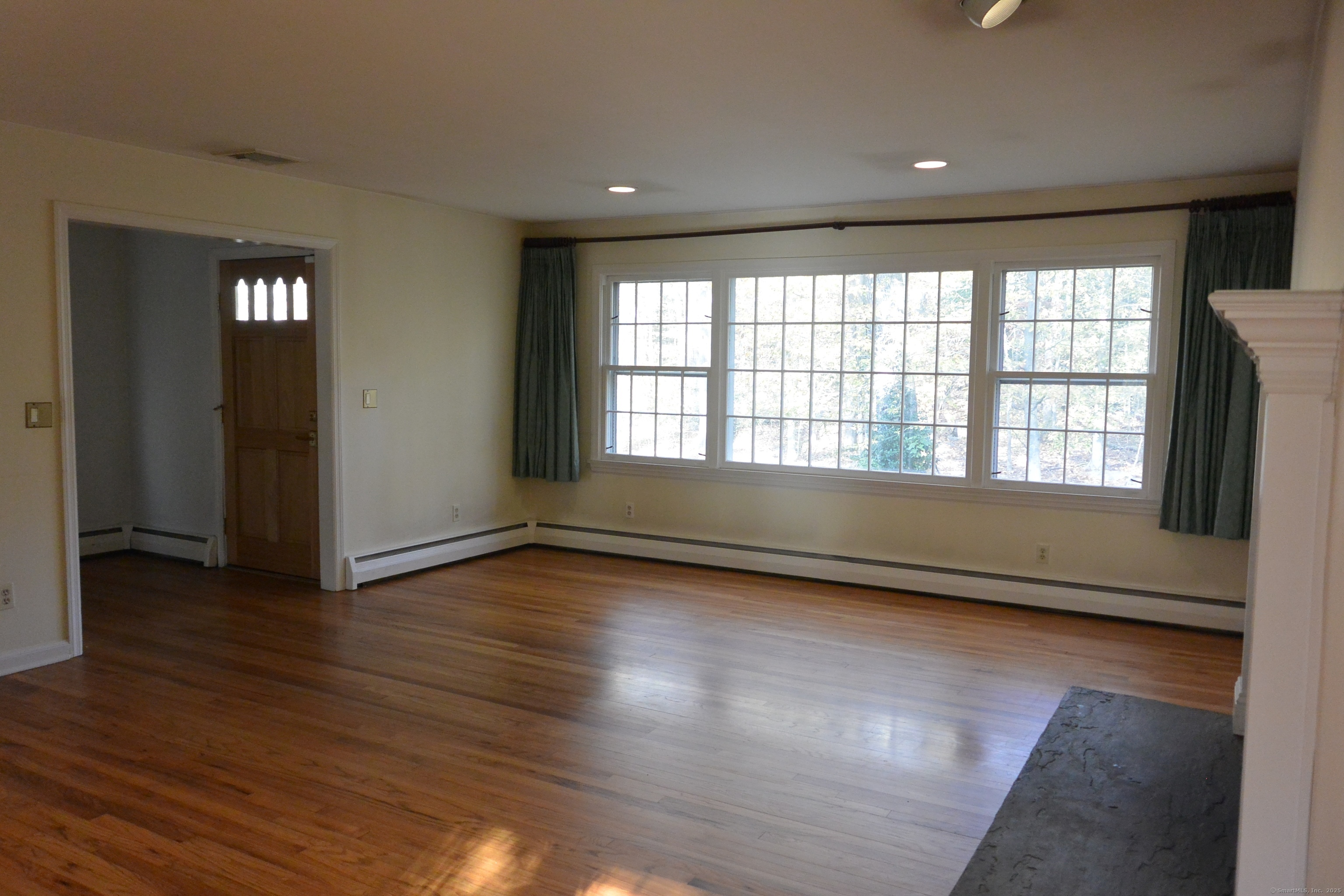439 Cheese Spring Road New Canaan, CT 06840 - Photo 6 of 36 a view of an empty room with wooden floor and a window