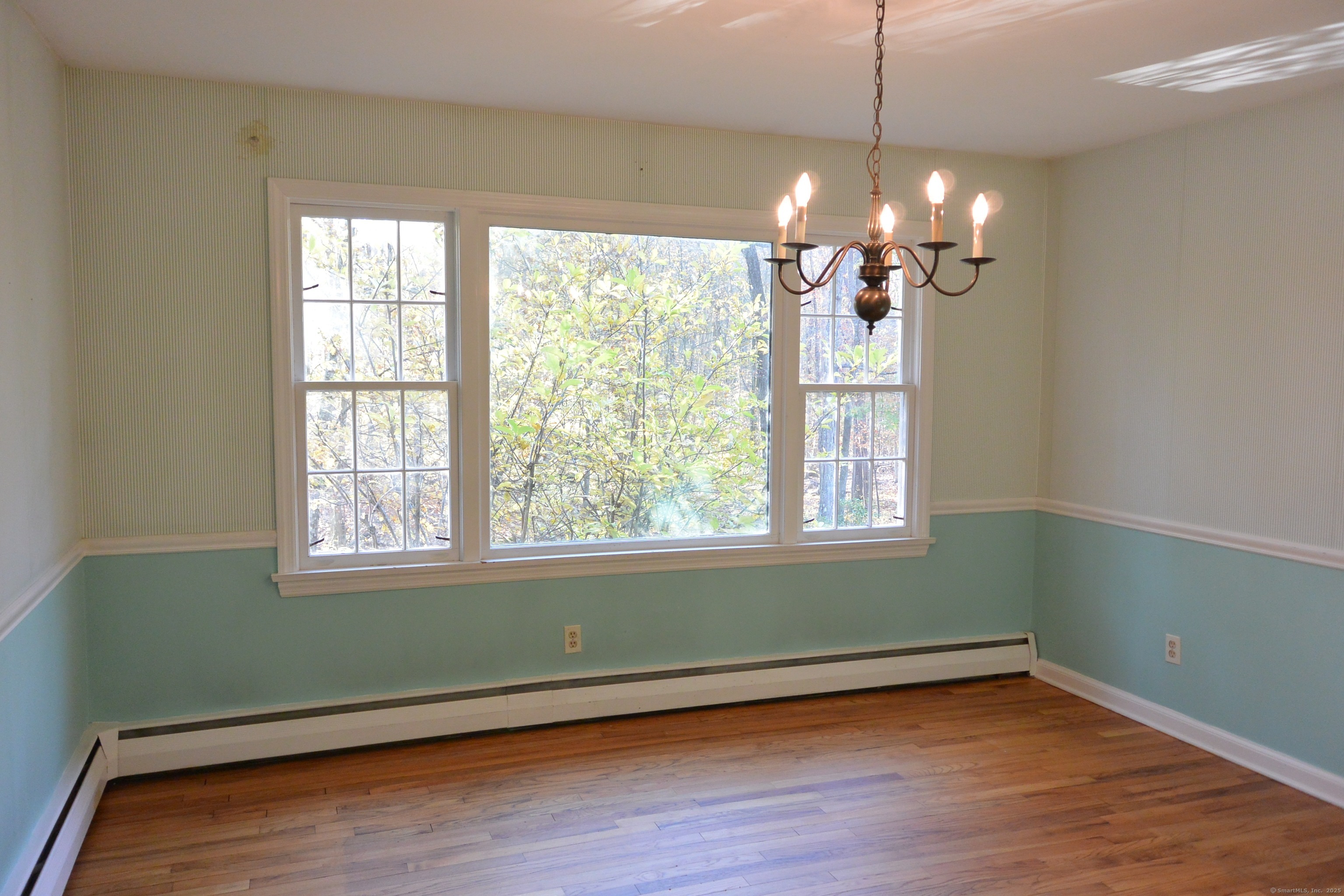 439 Cheese Spring Road New Canaan, CT 06840 - Photo 7 of 36 a view of an empty room with wooden floor and a window