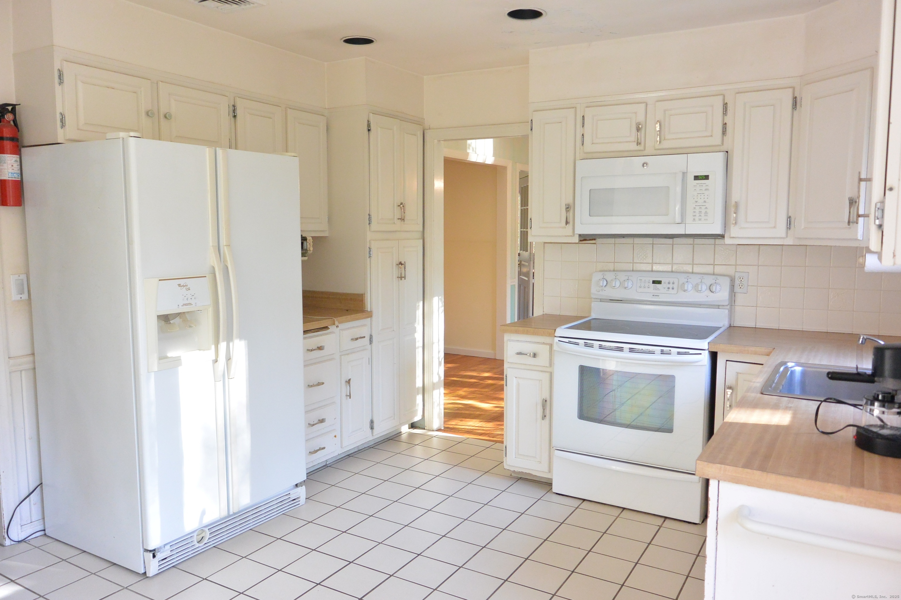 439 Cheese Spring Road New Canaan, CT 06840 - Photo 9 of 36 a kitchen with cabinets and a refrigerator