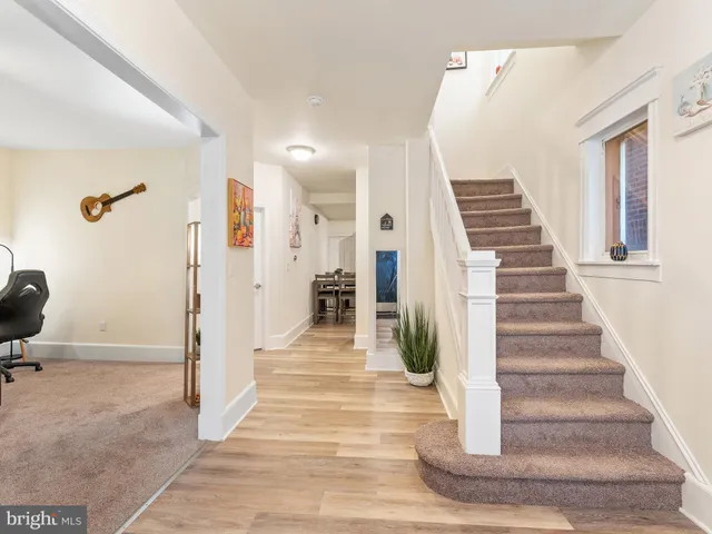 a view of entryway and hall with wooden floor