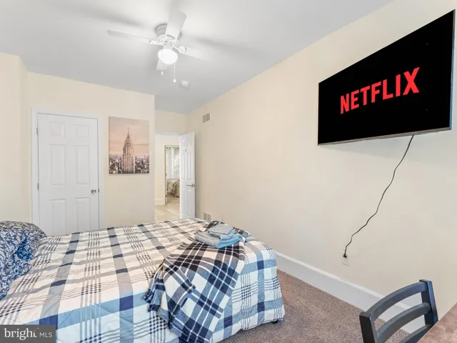 a bedroom with a bed and a painting on the wall