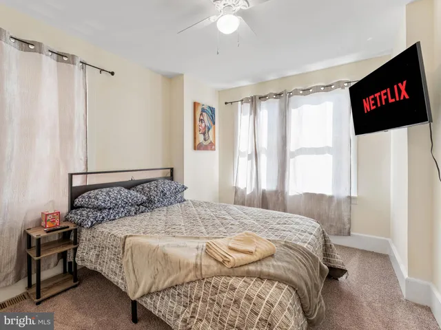 a bedroom with a bed and a flat screen tv