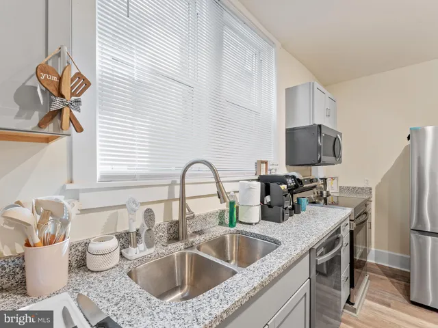 a kitchen with a sink appliances and cabinets