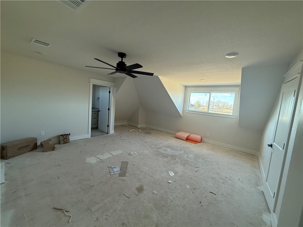 7822 Mathis Crk Drive Bryan, TX 77808 - Photo 13 of 20 en empty room with windows and fan