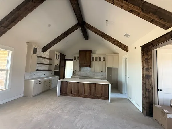 a large white kitchen with a stove and a refrigerator