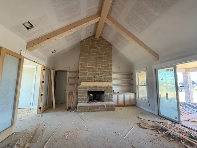 a view of a livingroom with fireplace and window