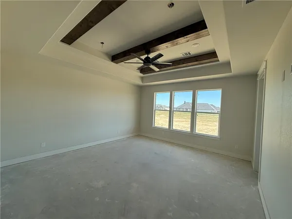 a view of room with a ceiling fan and window