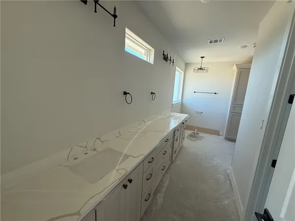 a bathroom with a tub sink and mirror