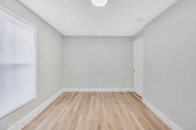 a view of room with wooden floor