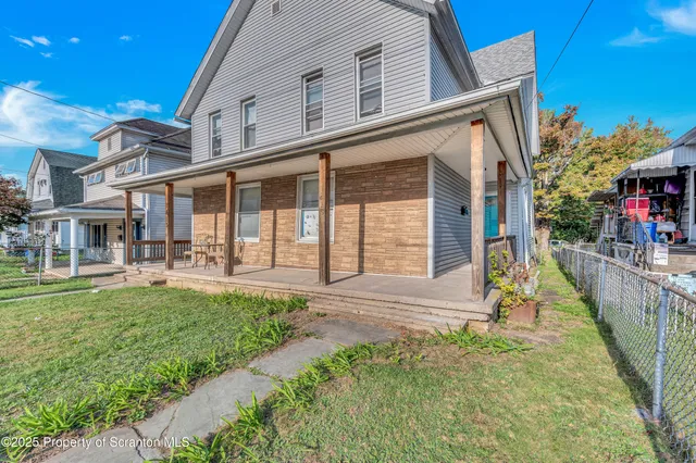 a view of a house with backyard and porch