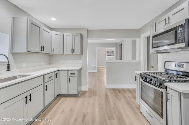 a kitchen with stainless steel appliances granite countertop a stove and a sink