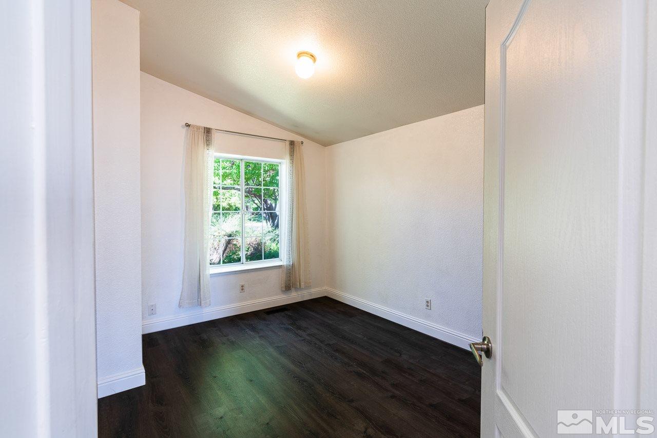 6542 Fall River Circle Reno, NV 89523 - Photo 13 of 17 an empty room with wooden floor and windows
