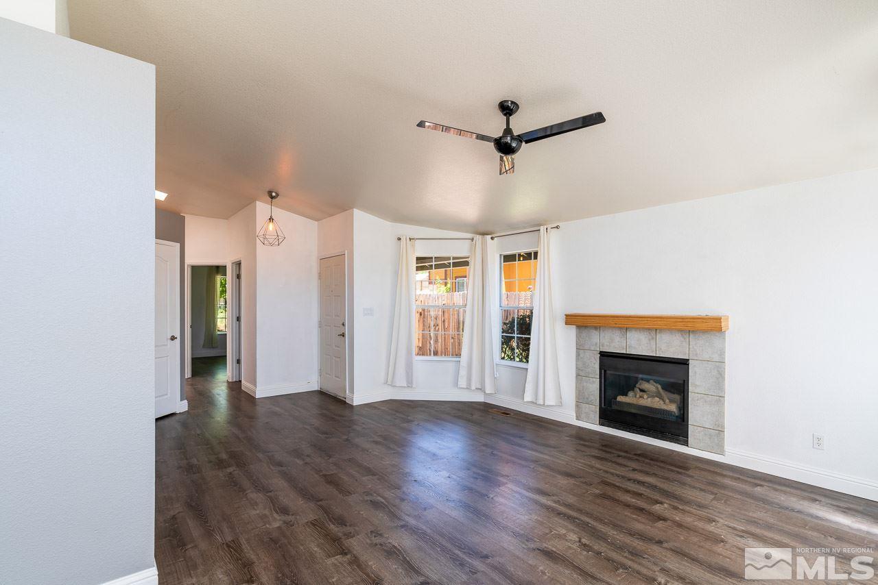 6542 Fall River Circle Reno, NV 89523 - Photo 4 of 17 a view of a livingroom with wooden floor and a ceiling fan
