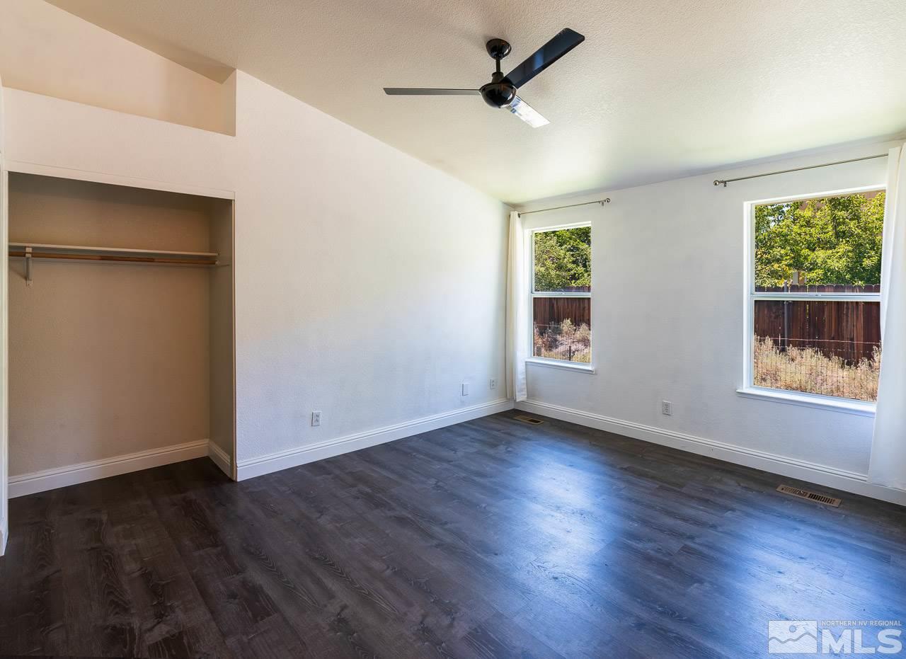 6542 Fall River Circle Reno, NV 89523 - Photo 8 of 17 a view of an empty room with wooden floor and a window