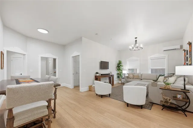 a kitchen with stainless steel appliances a stove and white cabinets