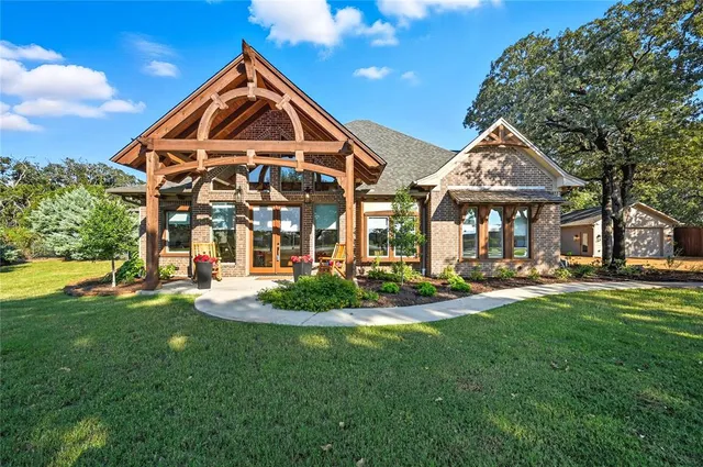 a front view of a house with swimming pool having outdoor seating