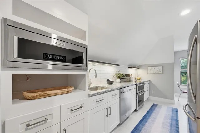 a dining room with a window and chairs