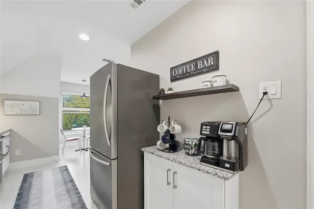 a living room with furniture a flat screen tv and a table