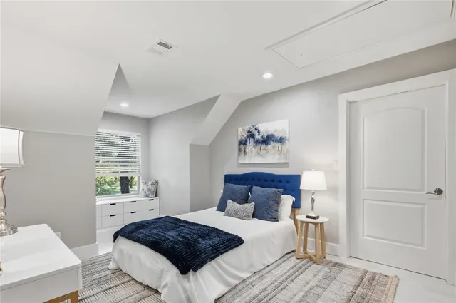 a living room with furniture and a book shelf