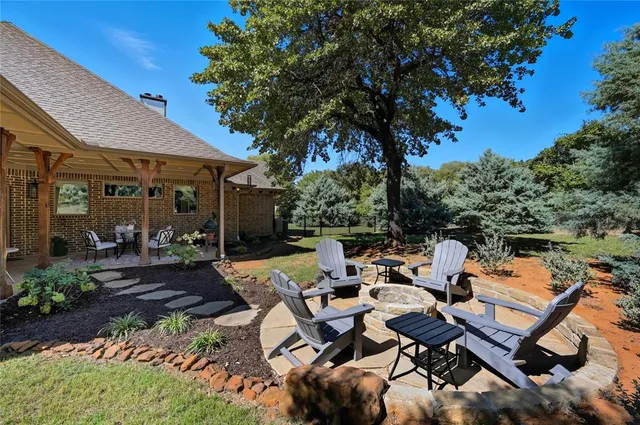 a backyard of a house with barbeque oven table and chairs