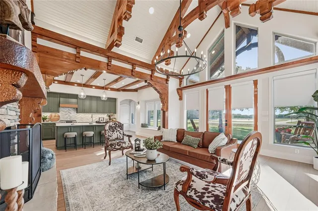 a dining room with furniture water view and large windows