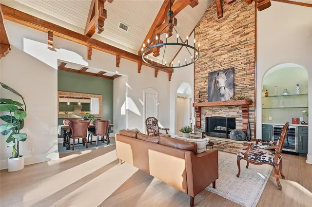 a living room with furniture a fireplace and a table