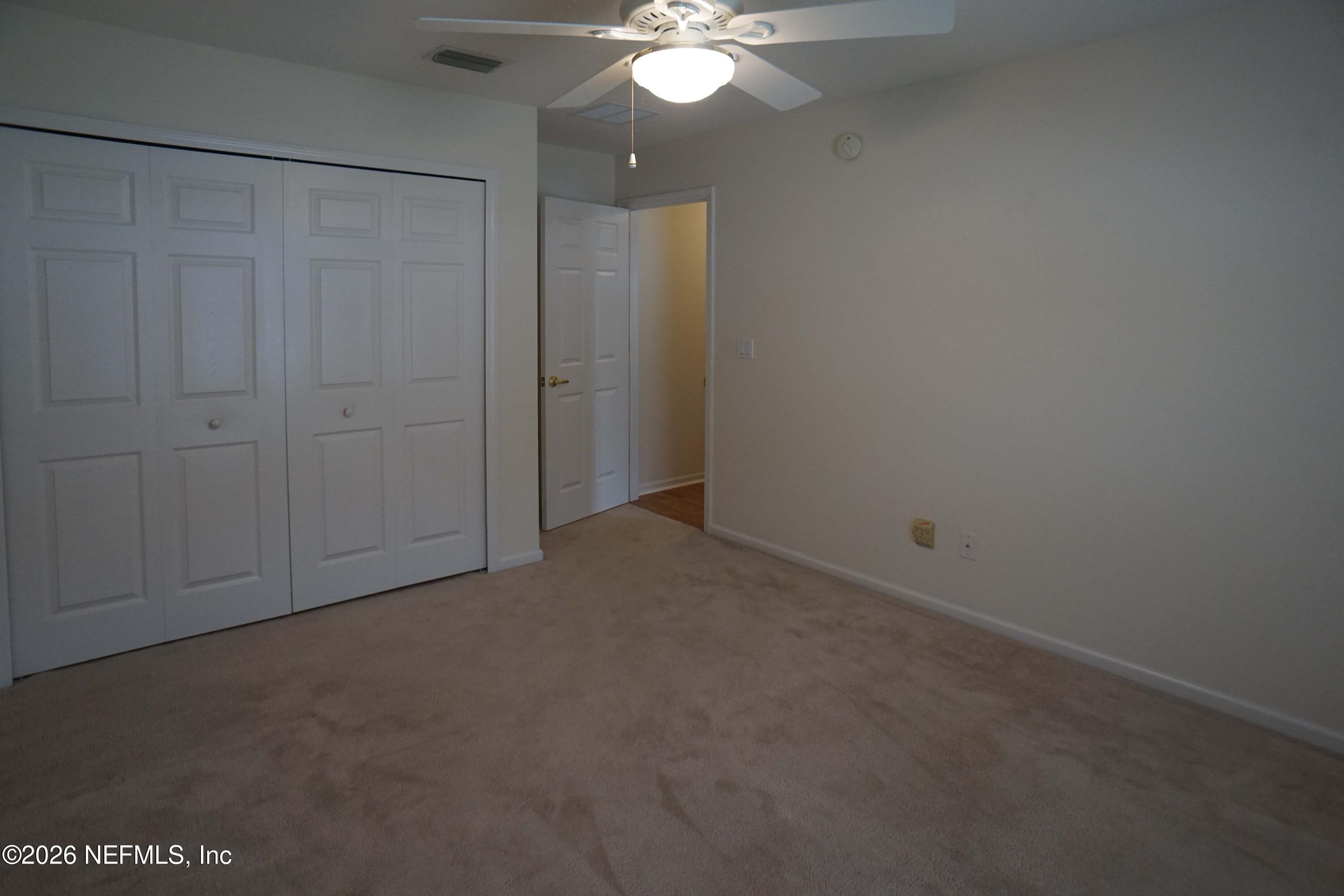 1721 Keswick Road St. Augustine, FL 32084 - Photo 12 of 17 a view of an empty room with a chandelier fan