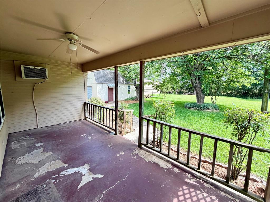 2030 Sycamore Street Paris, TX 75460 - Photo 18 of 24 Covered porch with a ceiling fan and a window-mounted air conditioning unit