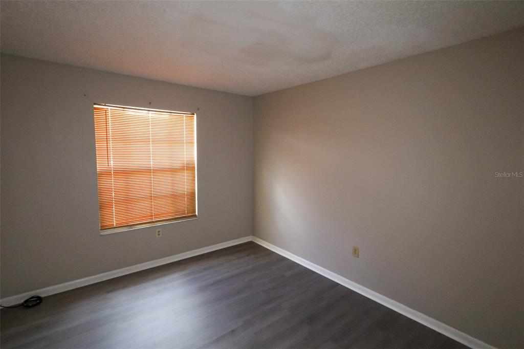 66 Silver Lane Ocala, FL 34472 - Photo 10 of 10 an empty room with wooden floor and windows