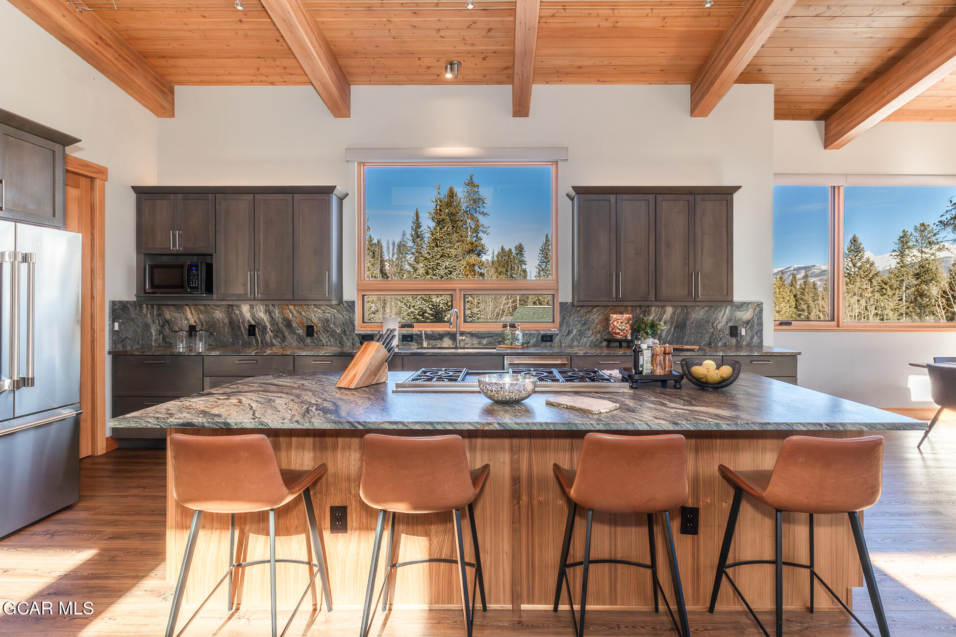 684 Vasquez Road Winter Park, CO 80482 - Photo 15 of 45 a kitchen with stainless steel appliances granite countertop a sink a stove a table and chairs