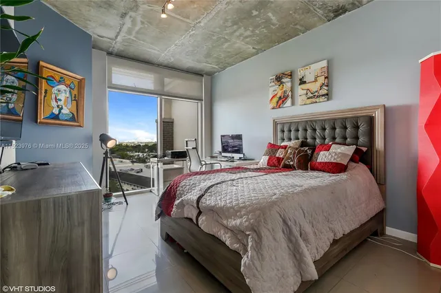 a bed sitting in a bedroom next to a window