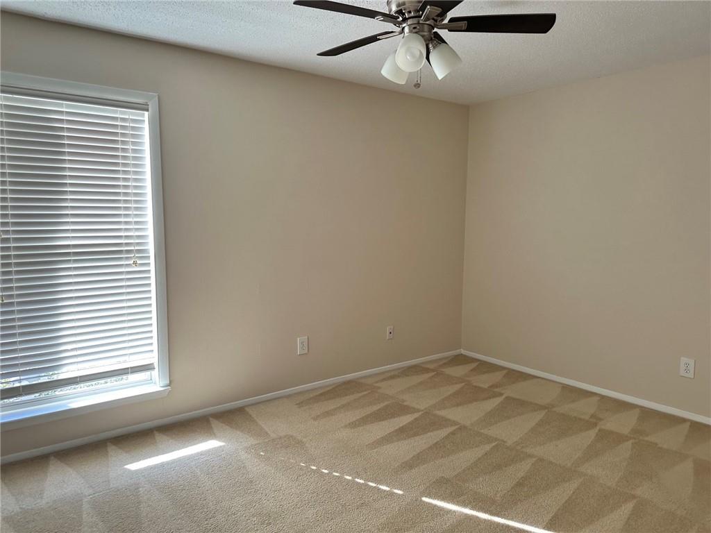 3301 Henderson Mill Road, Unit E7 Atlanta, GA 30341 - Photo 4 of 8 an empty room with a window and a fan