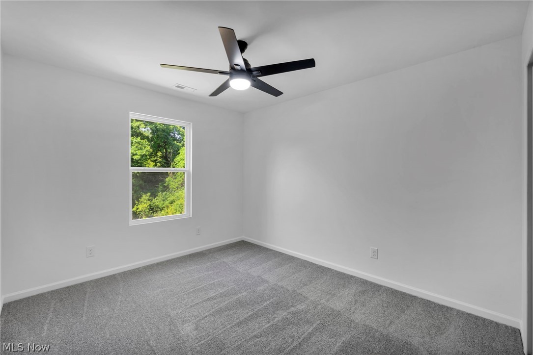 7602 Hickory Road Bedford, OH 44146 - Photo 19 of 36 Empty room with carpet flooring and ceiling fan