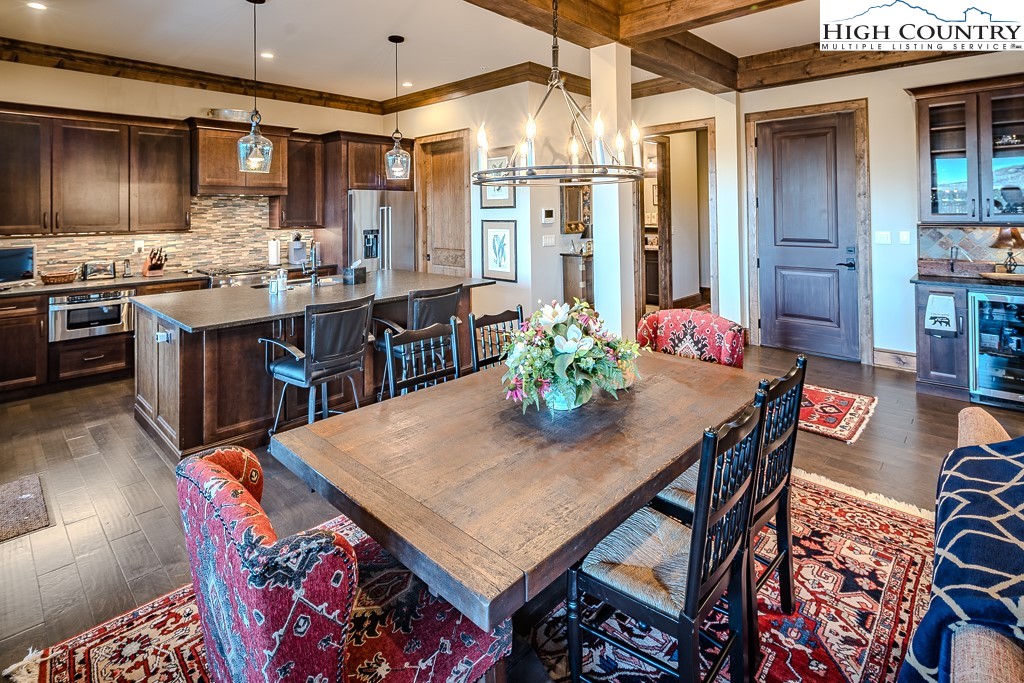 215 Cone Vista Circle, Unit B Blowing Rock, NC 28605 - Photo 20 of 50 a room with stainless steel appliances kitchen island granite countertop a dining table and chairs