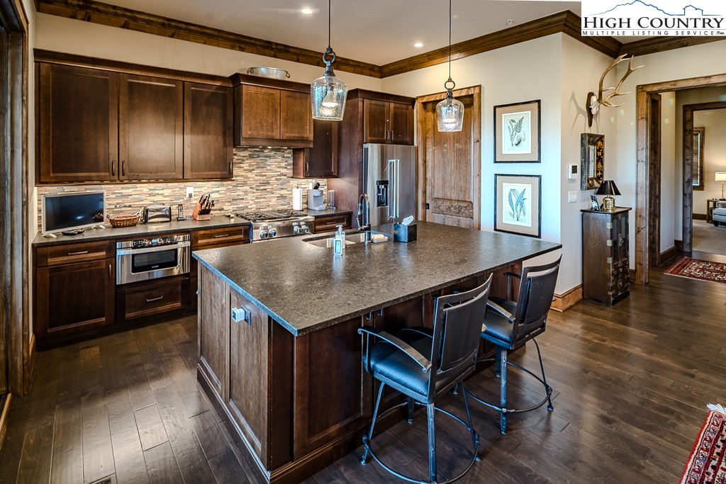215 Cone Vista Circle, Unit B Blowing Rock, NC 28605 - Photo 22 of 50 a kitchen with sink cabinets and wooden floor