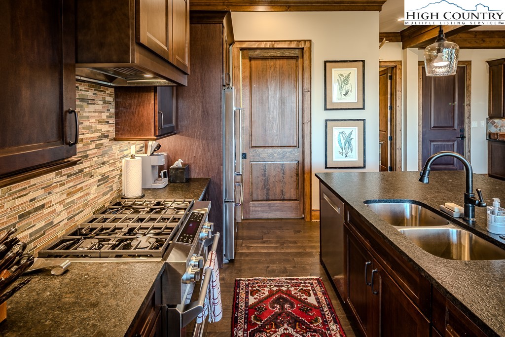 215 Cone Vista Circle, Unit B Blowing Rock, NC 28605 - Photo 29 of 50 a kitchen with a sink stove and cabinets