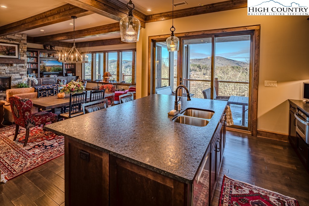 215 Cone Vista Circle, Unit B Blowing Rock, NC 28605 - Photo 30 of 50 a dining room with furniture window wooden floor and a table