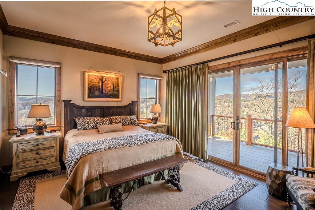 215 Cone Vista Circle, Unit B Blowing Rock, NC 28605 - Photo 32 of 50 a bedroom with a bed a dresser next to a window