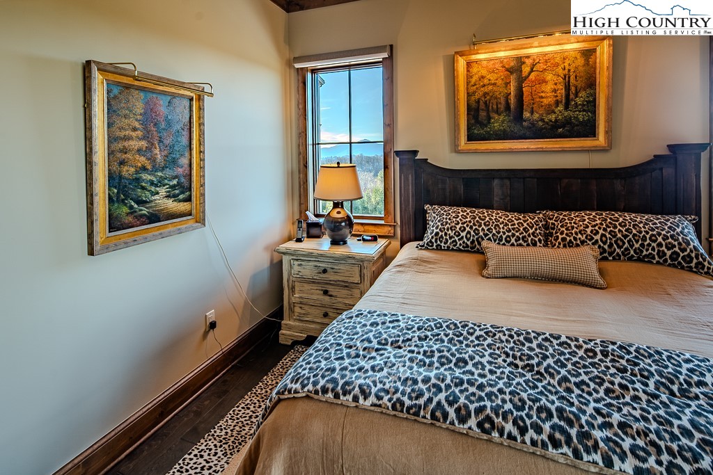 215 Cone Vista Circle, Unit B Blowing Rock, NC 28605 - Photo 34 of 50 a bedroom with a bed and wooden floor