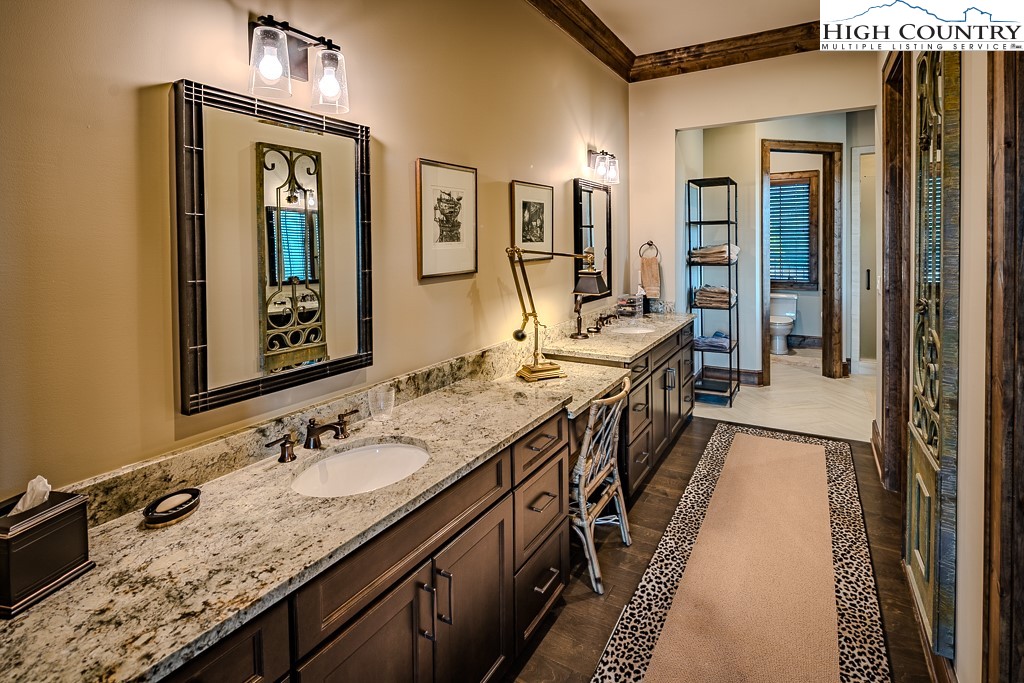 215 Cone Vista Circle, Unit B Blowing Rock, NC 28605 - Photo 39 of 50 a en suite bathroom with a granite countertop double vanity sink a mirror and shower