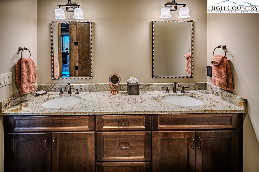 215 Cone Vista Circle, Unit B Blowing Rock, NC 28605 - Photo 45 of 50 a bathroom with a granite countertop sink and a mirror