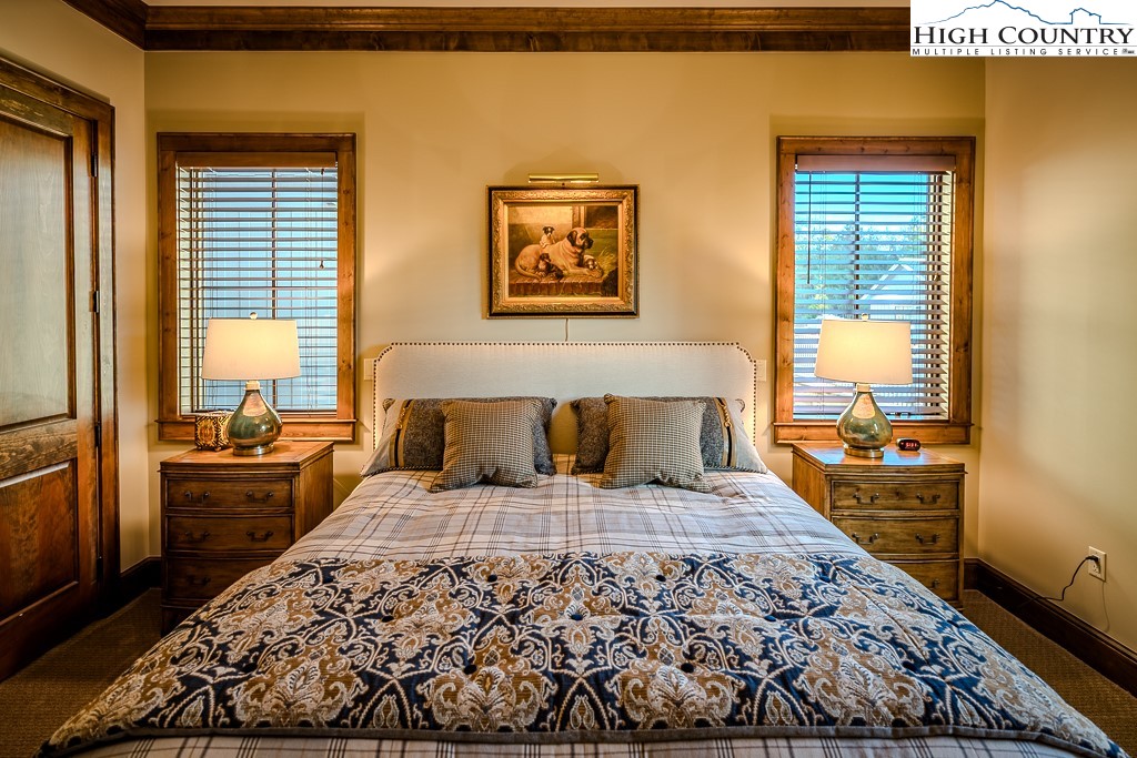 215 Cone Vista Circle, Unit B Blowing Rock, NC 28605 - Photo 47 of 50 a large bed in a bedroom next to a window with two dresser